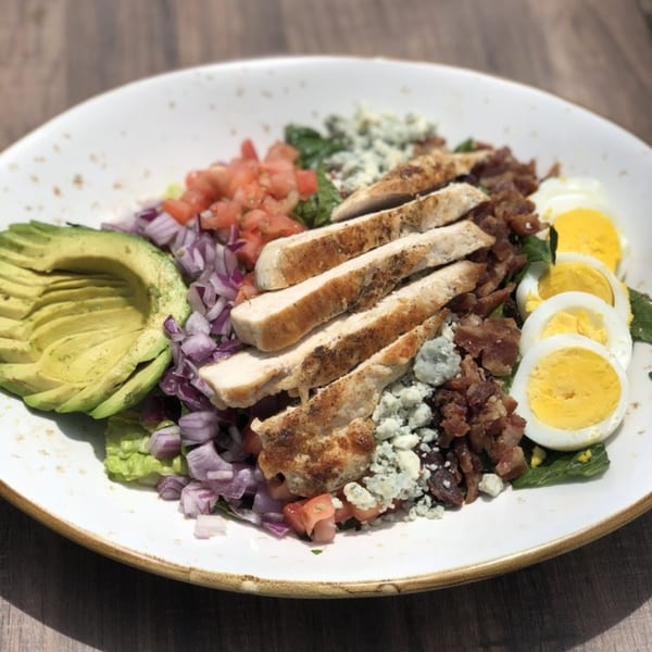 A Lake House Kitchen & Tavern Cobb salad with chicken, avocado, bacon, blue cheese, egg, and tomato.